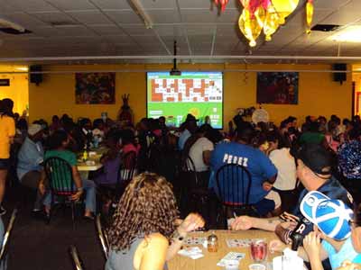 People gathered around large projector screen