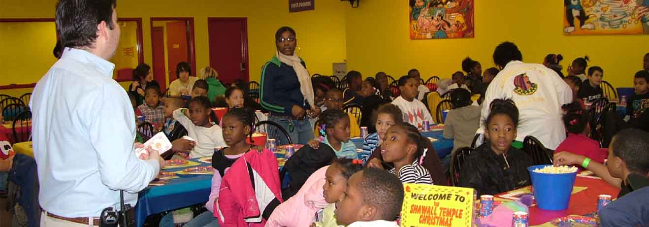 man instructing large group of children